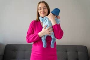 Mother holding her newborn baby at home during postpartum recovery