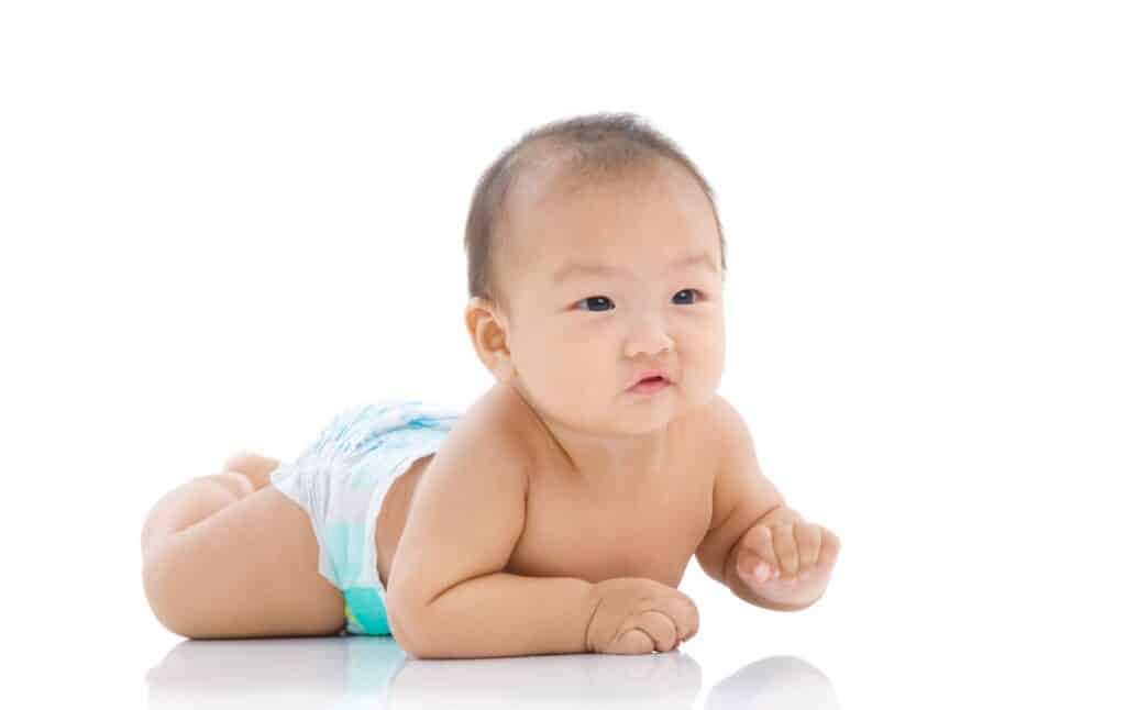 Baby doing tummy time, pushing up on hands as a sign of crawling readiness
