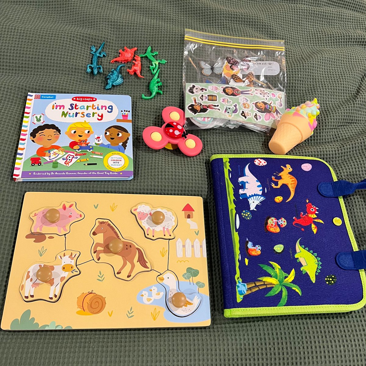 Toddler plane activities including a busy book, puzzle, stickers and small toys